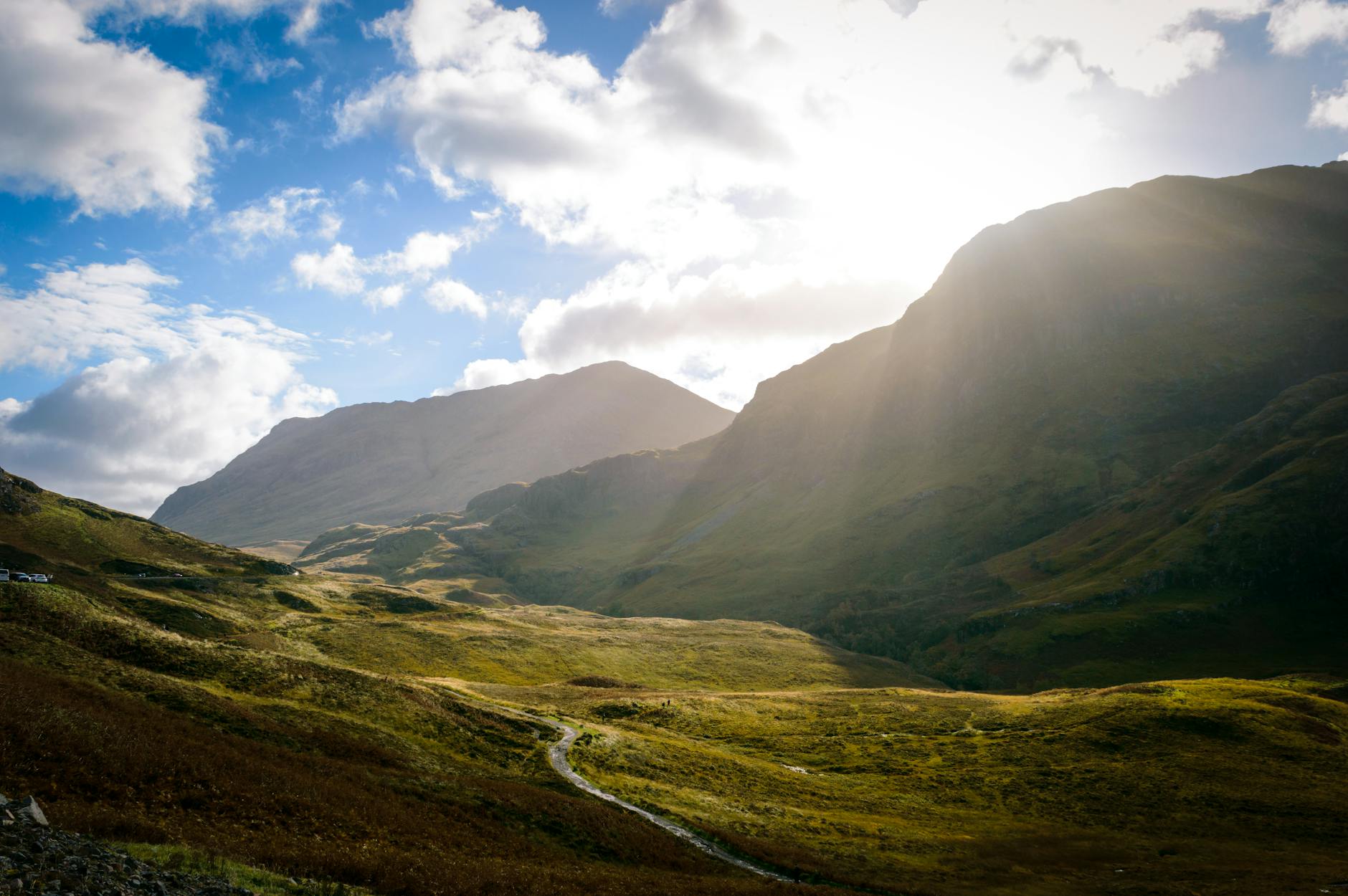 Dramatic Scottish Highlands with sunbeams over mountain valley