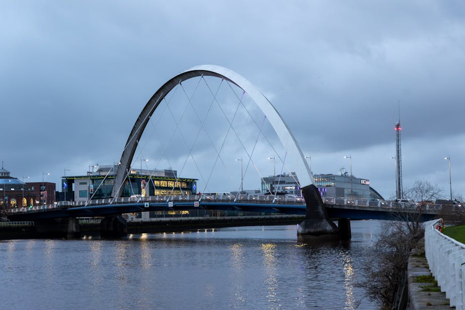 Illuminated Clyde Arc Bridge reflecting on the River Clyde at night in Glasgow