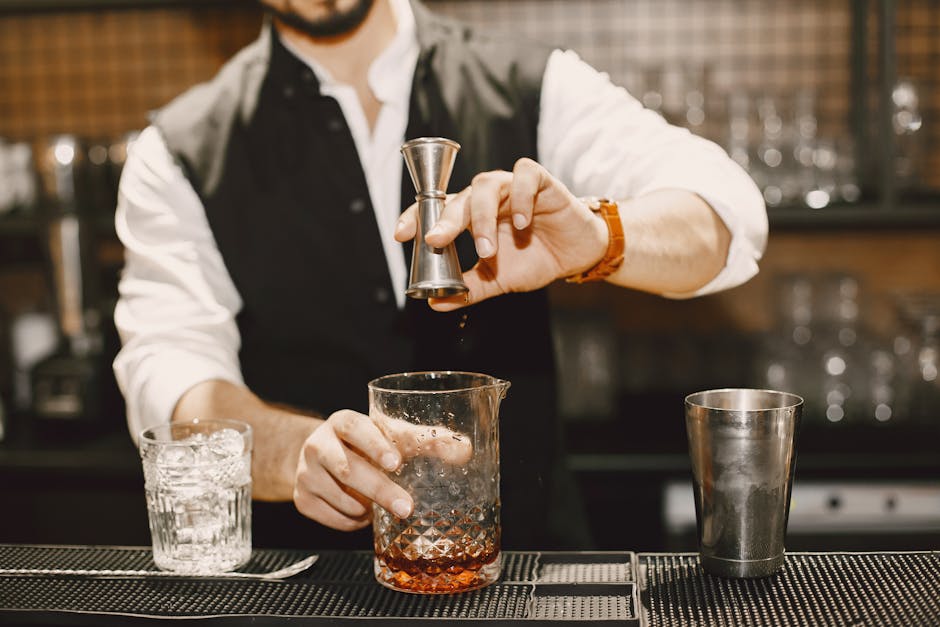 Expert bartender preparing an artisan cocktail at a Glasgow cocktail bar