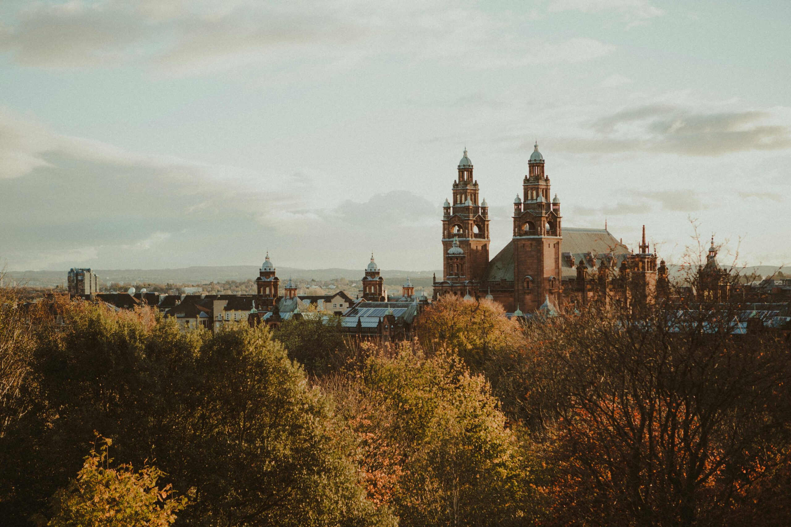 Things to do in Glasgow - Kelvingrove Art Gallery and Museum surrounded by autumn foliage in Glasgow