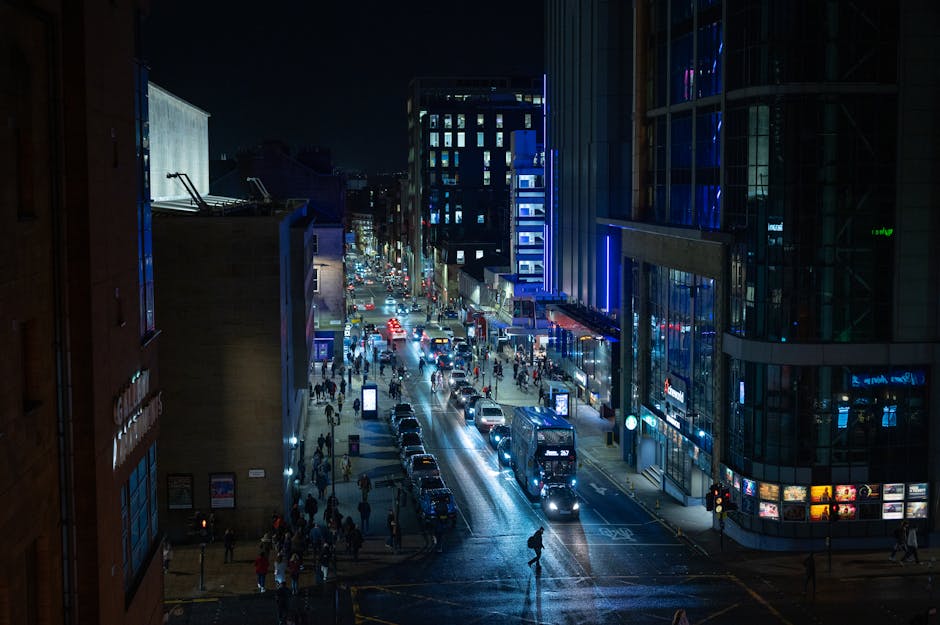Bustling nightlife and urban streets in Glasgow Merchant City with illuminated buildings