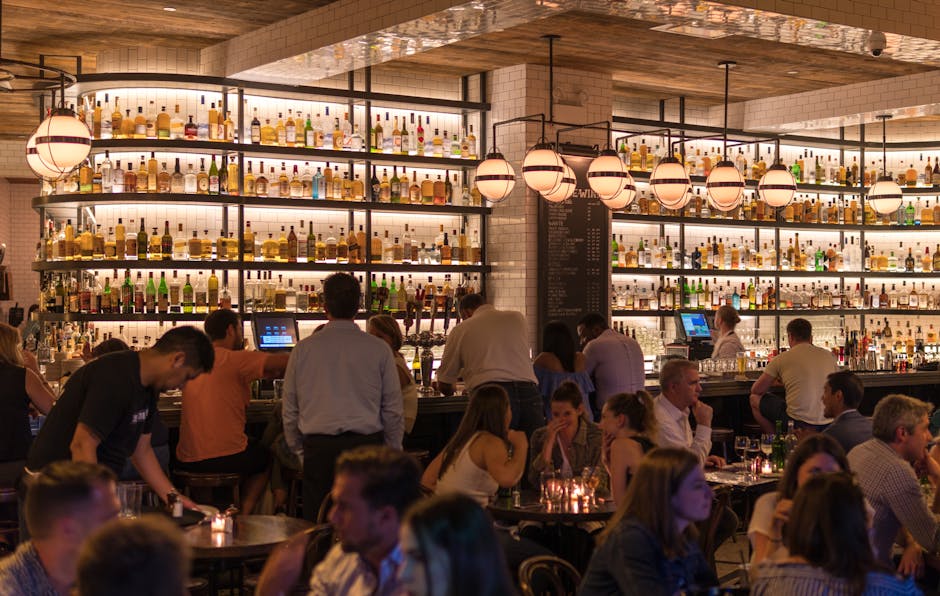 Glasgow nightlife - Atmospheric bar interior with warm lighting and rows of spirits bottles in Glasgow