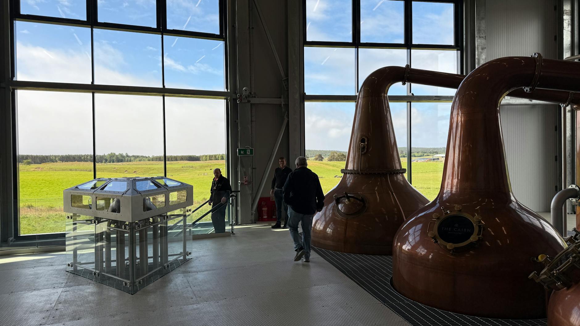 Copper pot stills inside a whisky distillery on a Glasgow whisky tours experience