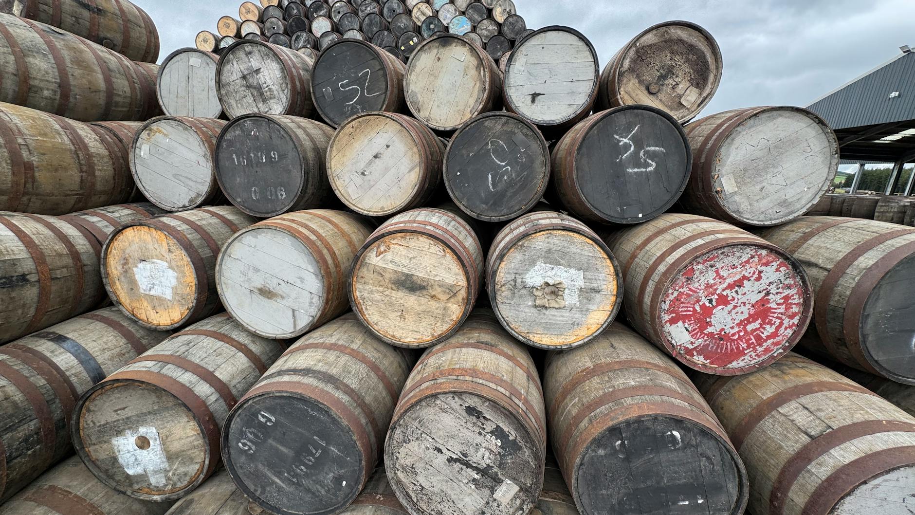 Whisky barrels aging in a Scottish distillery warehouse visited on Glasgow whisky tours