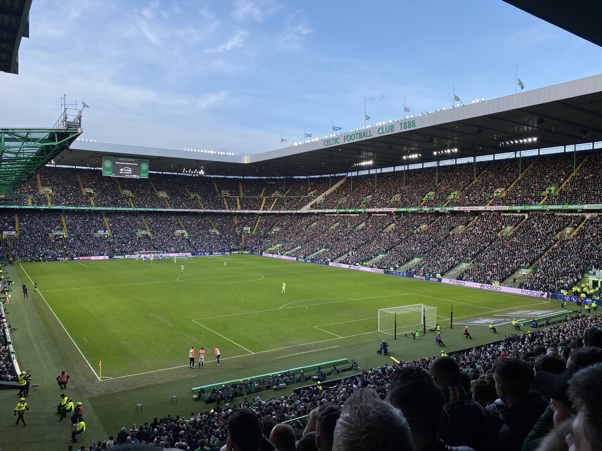 A packed Celtic Park seen from the upper tier during a match, with all four stands full