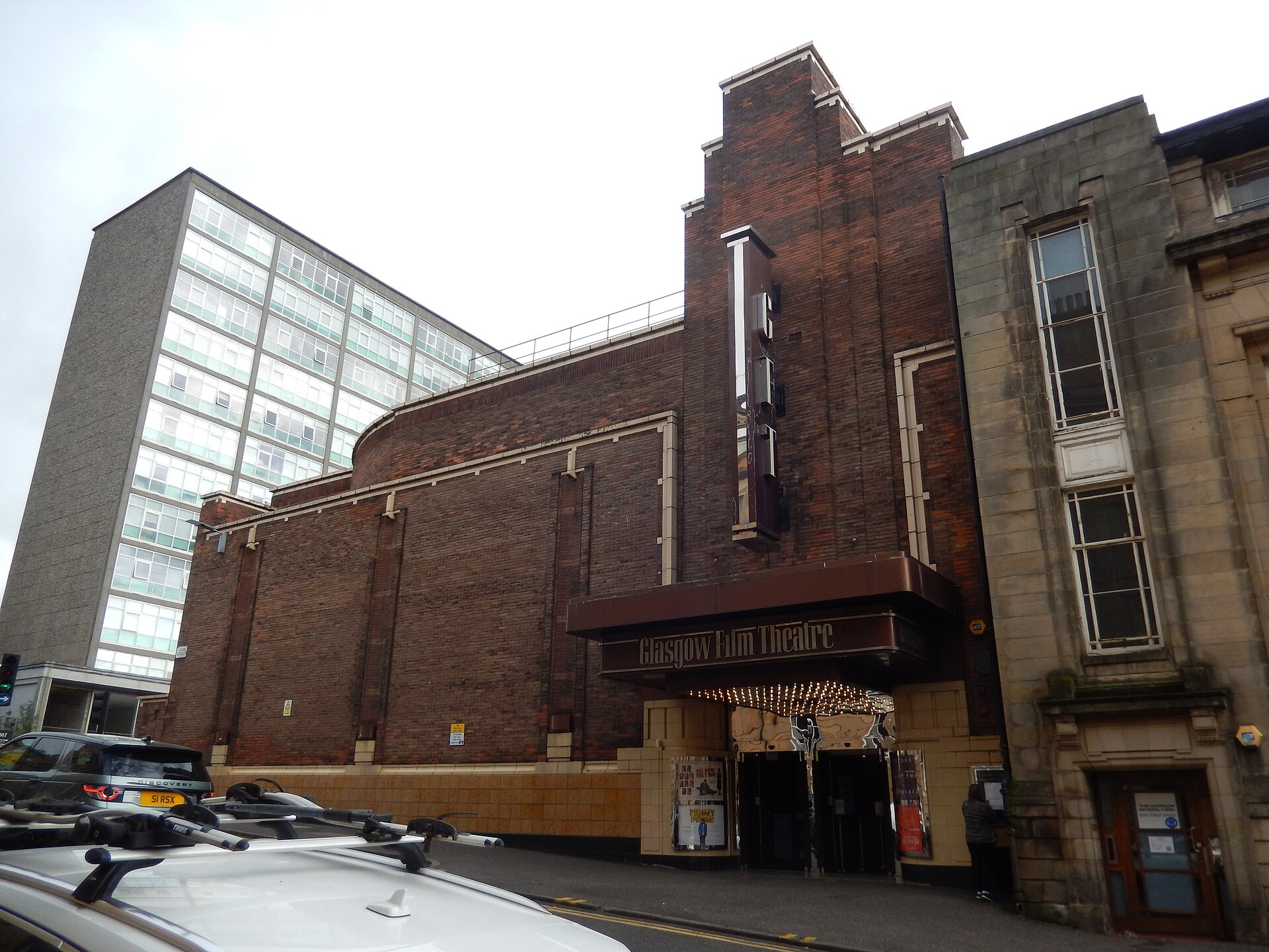 The brick art deco Glasgow Film Theatre on Rose Street, with its vertical GFT sign, a dark canopy over the entrance and film posters by the doors