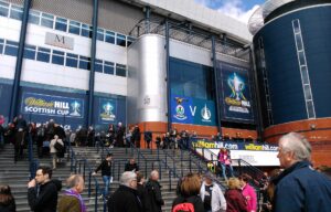 Crowds climbing the wide external steps to the south stand entrance at Hampden Park on a Scottish Cup final day