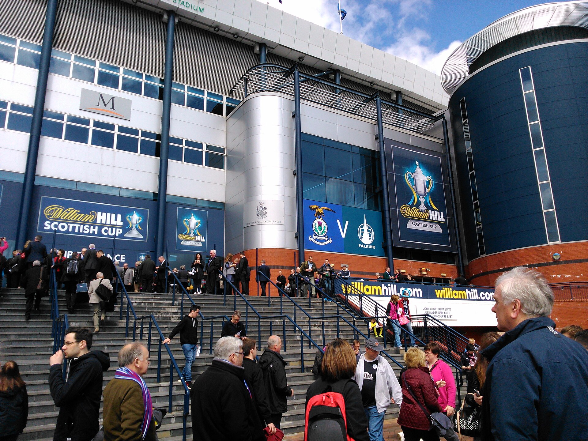 Crowds climbing the wide external steps to the south stand entrance at Hampden Park on Scottish Cup Final day