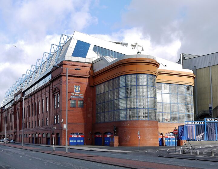 The red-brick Bill Struth Main Stand at Ibrox on Edmiston Drive, with its curved glass-block corner and club crest