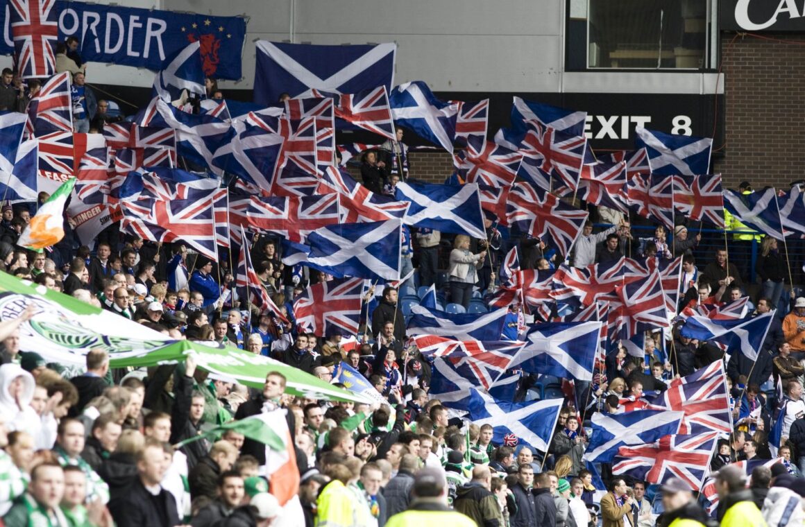 Union flags and saltires on one side of a stand meeting Irish tricolours and green banners on the other during an Old Firm derby